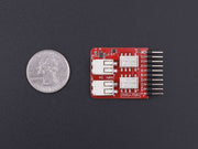 Tessel Relay Module front view with size comparison to a coin