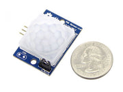 PIR Motion Sensor - Large Lens Version top view with size comparison to a coin